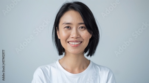 The smiling Asian woman.