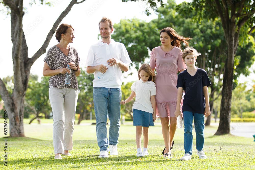 Caucasian family parent and their children picnic at the park in morning. Caucasian family parent and their children picnic at the park in morning.