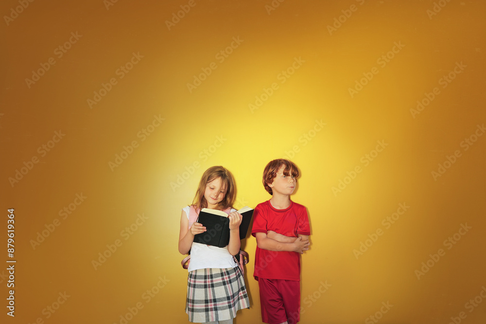 Fototapeta premium Different children - little girl has interest in learning and boy who has no interest in learning.