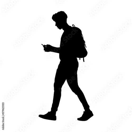 Silhouette of a man walking while using a smartphone