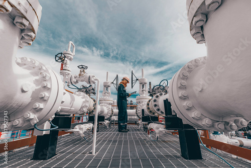 Male worker inspection at steel long pipes and pipe elbow in station oil factory during refinery valve of visual check record pipeline oil