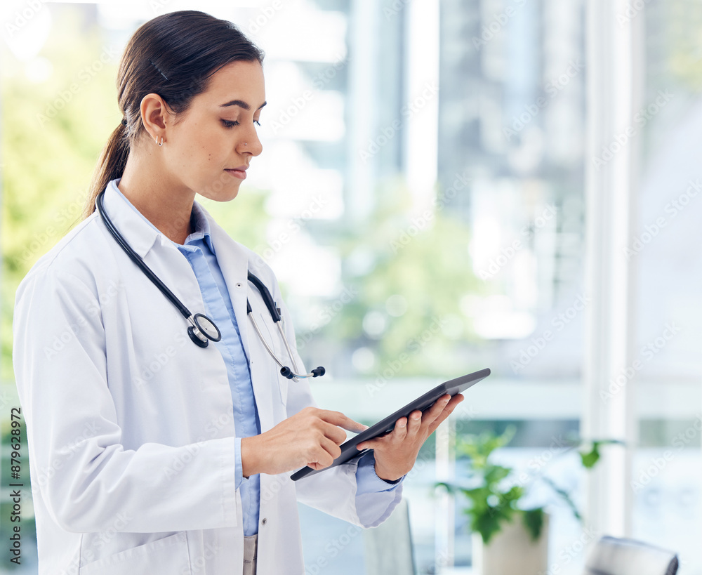 Healthcare, female doctor and serious with tablet for research, reading and scroll for medical information. Clinic, woman cardiologist and digital for efficient workflow, patient record and browse Healthcare, female doctor and serious with tablet for research, reading and scroll for medical information. Clinic, woman cardiologist and digital for efficient workflow, patient record and browse