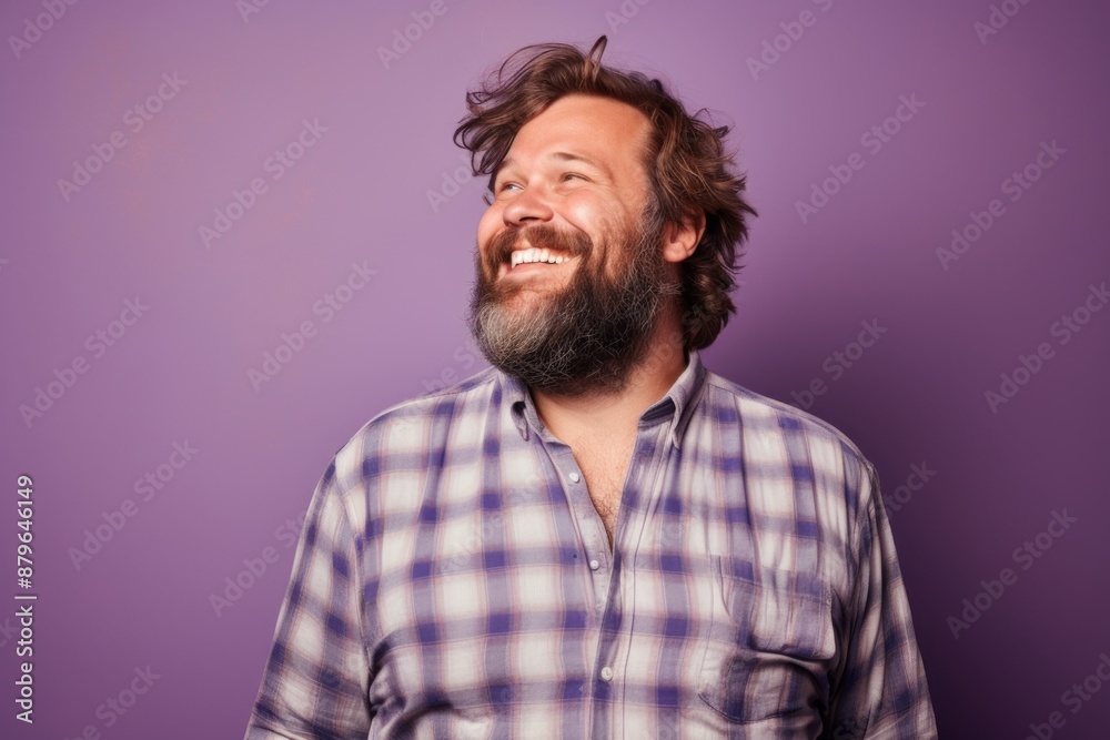 Portrait of a joyful man in his 30s dressed in a relaxed flannel shirt over solid pastel color wall Portrait of a joyful man in his 30s dressed in a relaxed flannel shirt over solid pastel color wall