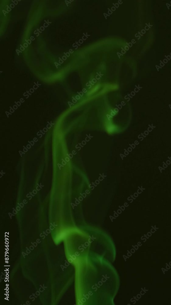 Smoke incense stick close-up on a dark background. Vertical video. Smoke incense stick close-up on a dark background. Vertical video.