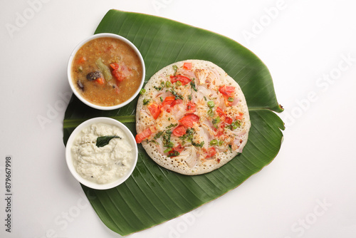 Uthappam or Uttapam is a type of dosa from southern India that is thicker, with tomato, onion, chilli packets. photo