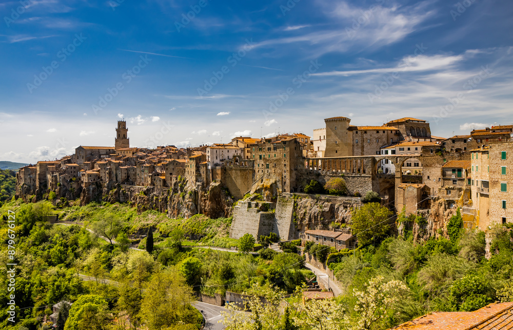 A glimpse of the ancient medieval village of Pitigliano, in the province of Grosseto, Tuscany, Italy. Is known as the little Jerusalem. The old stone houses built overlooking a spur of tuff rock. A glimpse of the ancient medieval village of Pitigliano, in the province of Grosseto, Tuscany, Italy. Is known as the little Jerusalem. The old stone houses built overlooking a spur of tuff rock.