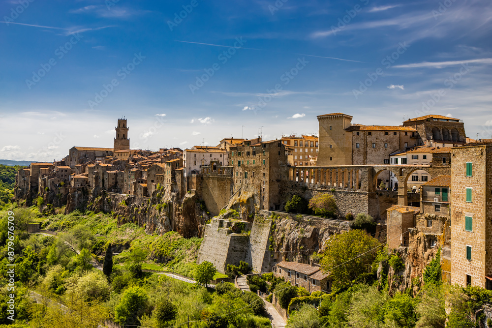 A glimpse of the ancient medieval village of Pitigliano, in the province of Grosseto, Tuscany, Italy. Is known as the little Jerusalem. The old stone houses built overlooking a spur of tuff rock. A glimpse of the ancient medieval village of Pitigliano, in the province of Grosseto, Tuscany, Italy. Is known as the little Jerusalem. The old stone houses built overlooking a spur of tuff rock.