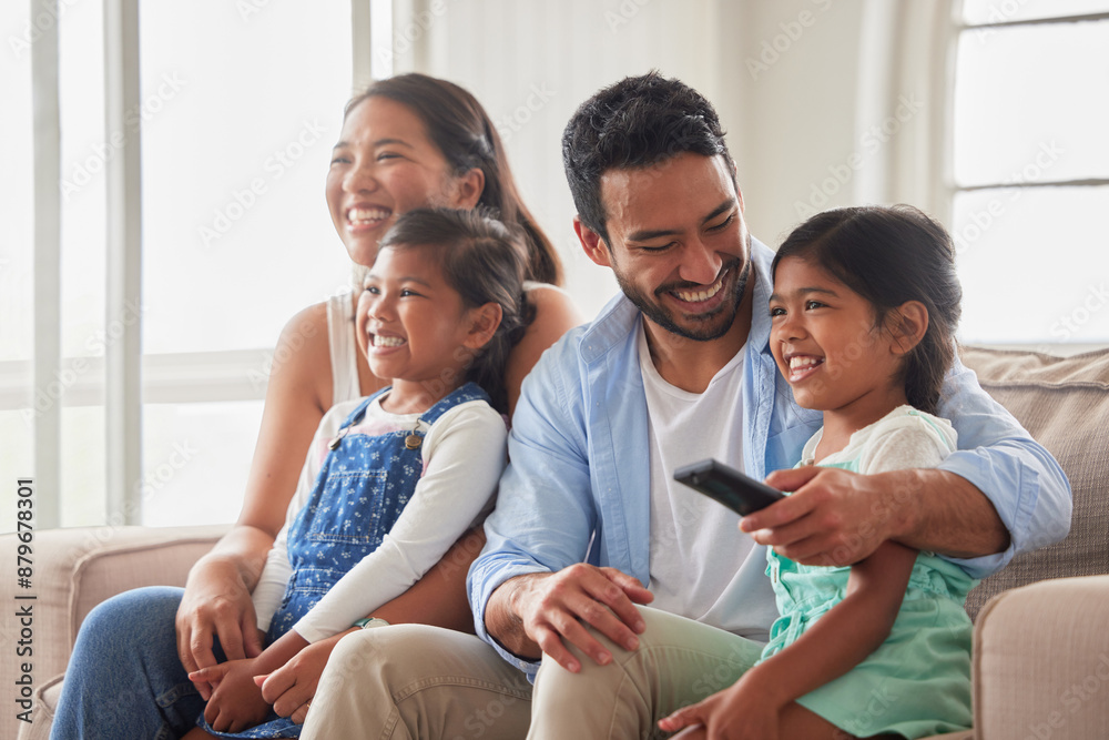 Parents, girl and children for watching tv on sofa with remote, hug and happy for show in family home. Father, mother and daughter kids with streaming, subscription and relax with movie in Indonesia Parents, girl and children for watching tv on sofa with remote, hug and happy for show in family home. Father, mother and daughter kids with streaming, subscription and relax with movie in Indonesia