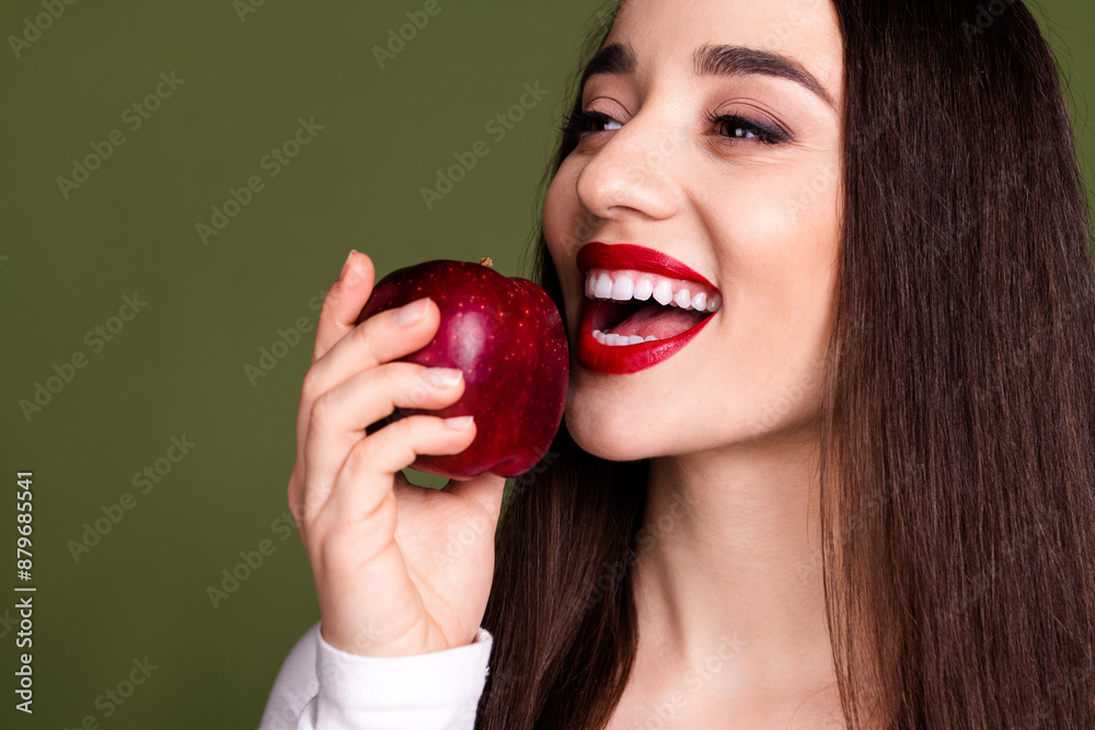 Cropped photo of pretty young girl eating apple wear trendy white outfit isolated on khaki color background Cropped photo of pretty young girl eating apple wear trendy white outfit isolated on khaki color background