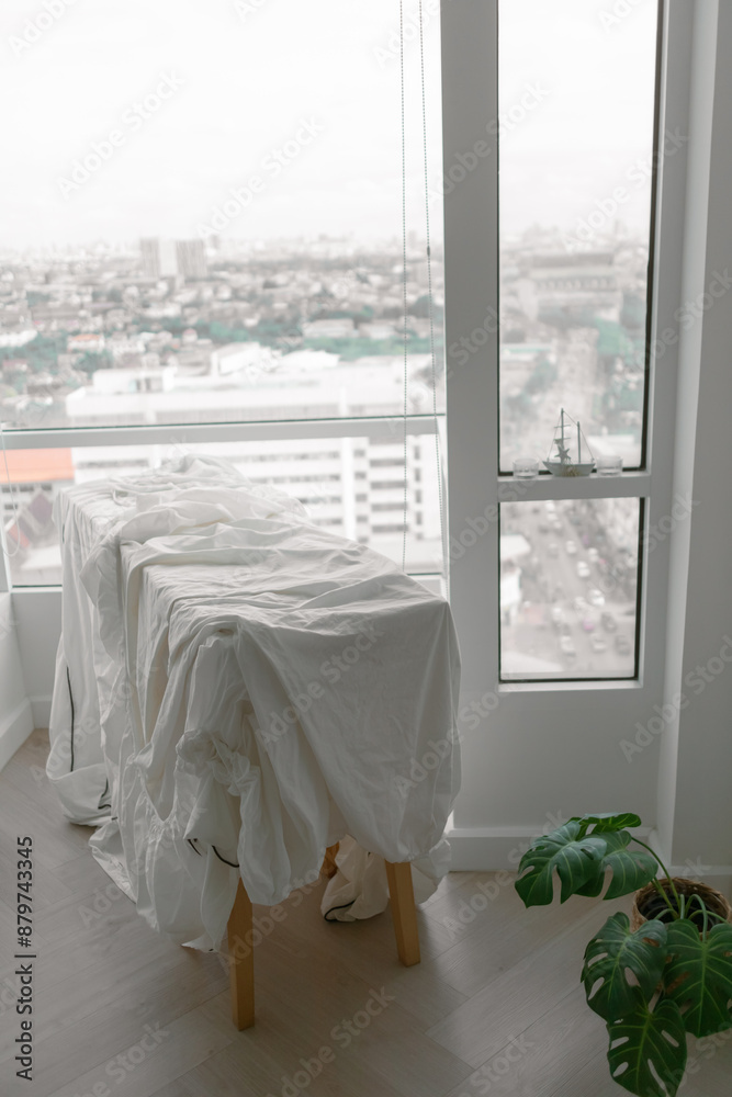 White bed sheets hanging after wash at the balcony of the apartment.. White bed sheets hanging after wash at the balcony of the apartment..