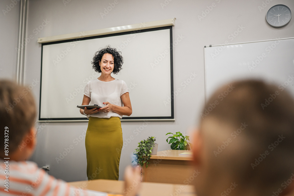 Mature teacher teach a lesson young students and hold tablet Mature teacher teach a lesson young students and hold tablet