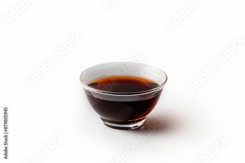 Clear cup showing side view of soy sauce on white background