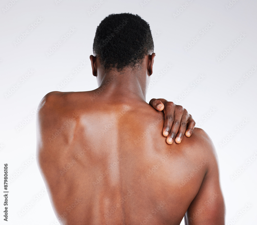 Black man, back and pain with injury in fitness for muscle tension, sprain or joint inflammation on a white studio background. Young African, male person or model with sore trapezius, bruise or ache Black man, back and pain with injury in fitness for muscle tension, sprain or joint inflammation on a white studio background. Young African, male person or model with sore trapezius, bruise or ache