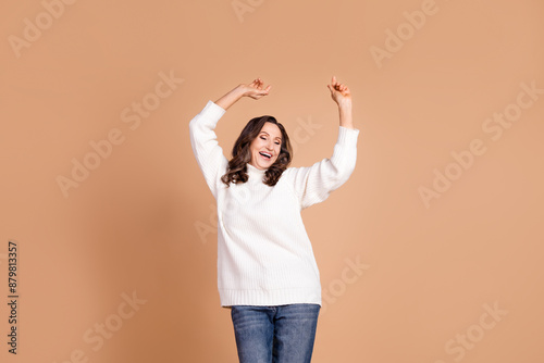 Photo of glad positive lovely senior woman wear trendy clothes good mood dance isolated on beige color background