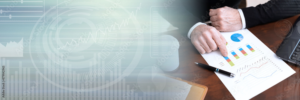 Businessman analysing marketing graphs; panoramic banner Businessman analysing marketing graphs; panoramic banner