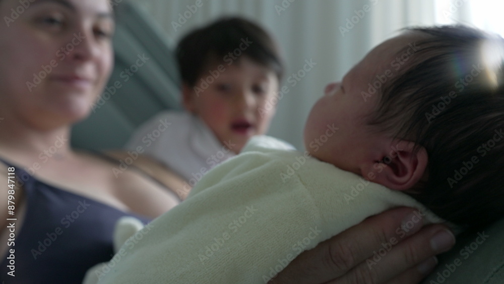 Mother and older sibling cuddling close to newborn baby, smiling warmly. intimate family moment captures the love and bond between mother and children Mother and older sibling cuddling close to newborn baby, smiling warmly. intimate family moment captures the love and bond between mother and children