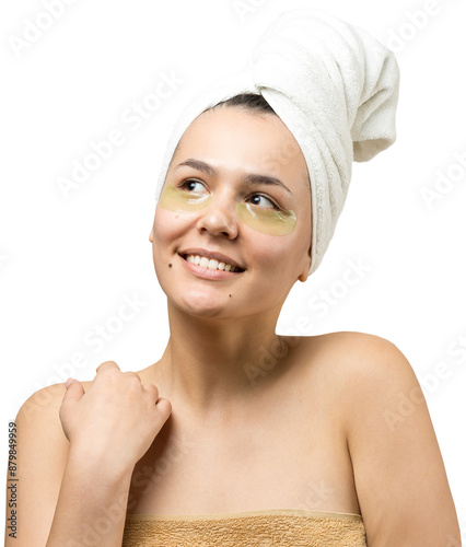 Young beautiful girl in a white towel on his head wears collagen gel patches under her eyes. Mask under eyes treatment face.