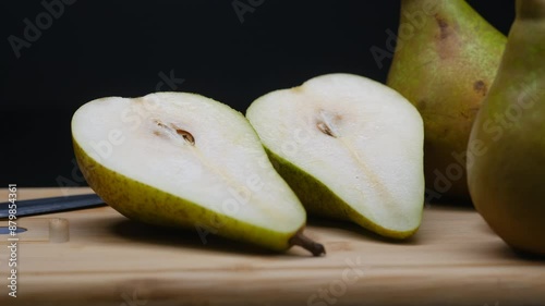 a green pear on a dark background