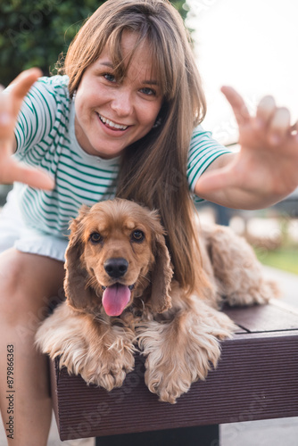 Young woman having fun with her dog photo