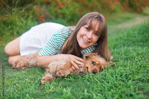 cocker Spaniel dog having fun and playing with young beautiful woman