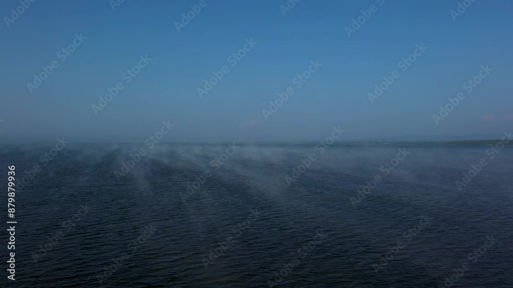 Misty Morning Over Ocean with Blue Sky, Gentle Waves, Serene Atmosphere, and Calm Environment