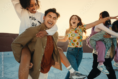 Playful friends enjoying summer day together on rooftop photo