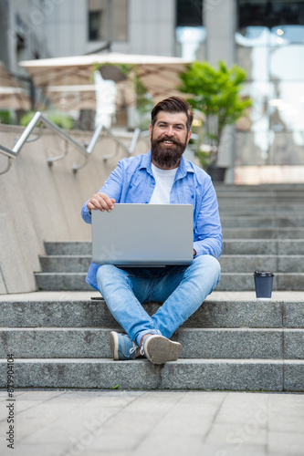 man freelancer smile has video call outdoor. man freelancer has video call on laptop.