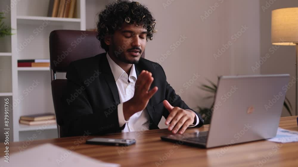 Portrait of handsome young indian businessman having video call conference meeting by laptop computer at office workplace Confident male talking on working conversation indoors Portrait of handsome young indian businessman having video call conference meeting by laptop computer at office workplace Confident male talking on working conversation indoors
