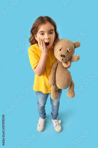 Shocked little girl with te...