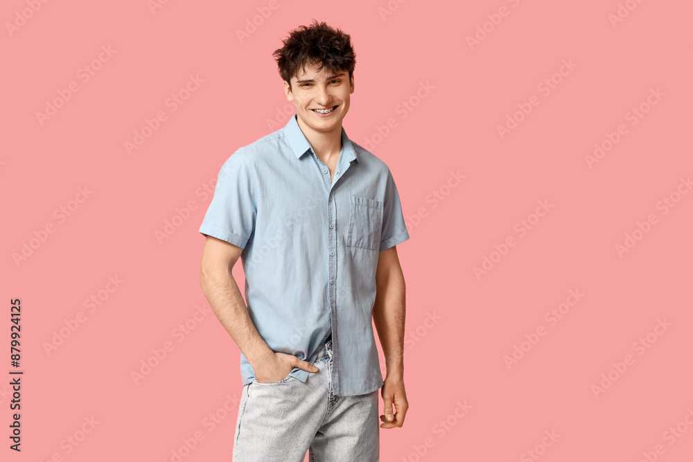 Fototapeta premium Handsome young man in stylish clothes on pink background