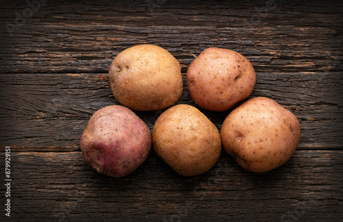 Colombian organic fresh potato on wooden background - Solanum tuberosum photo