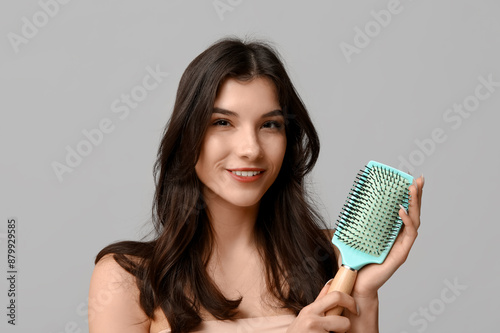 Smiling young woman holding...