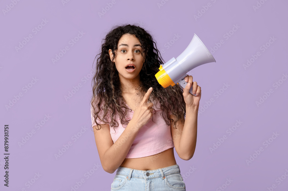 Surprised African-American woman with megaphone on lilac background