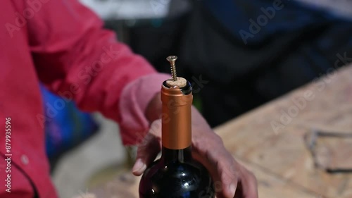 Learn how to remove a wine bottle cork using a screw and pliers in a workshop. Innovative technique