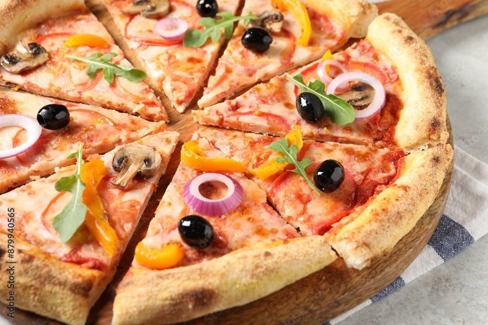 Cut delicious vegetarian pizza on light table, closeup Cut delicious vegetarian pizza on light table, closeup