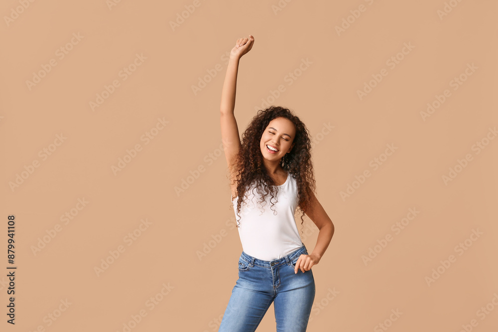 Happy young African-American woman on beige background Happy young African-American woman on beige background