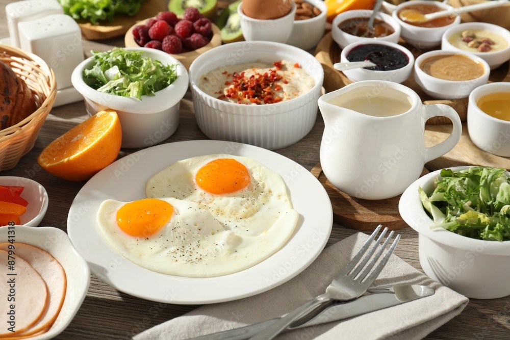 Different meals served for breakfast on wooden table