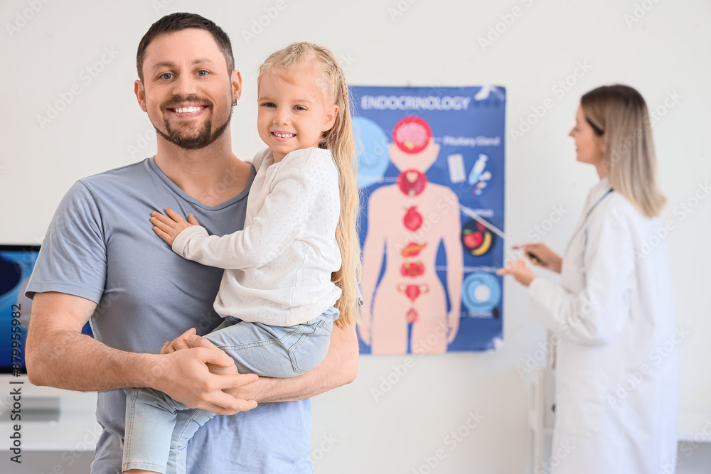 Fototapeta premium Father with his little daughter visiting endocrinologist in clinic