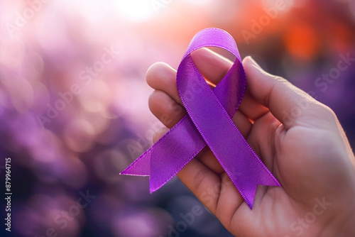 Hand with purple ribbon on purple background of cancer awareness illustration, copy space photo