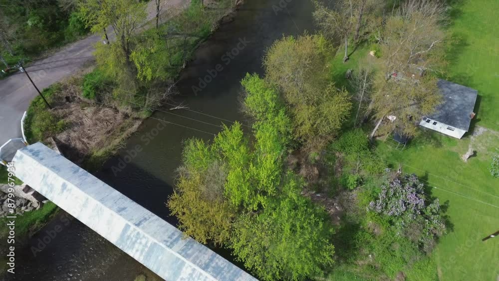 Herline covered bridge near Manns Choice PA. Very high angle flyover shot of the bridge and stream below. Herline covered bridge near Manns Choice PA. Very high angle flyover shot of the bridge and stream below.