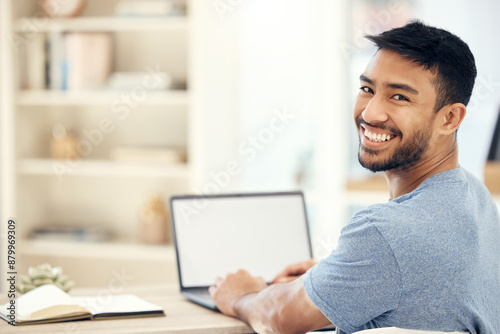 Mockup, laptop screen and portrait of man in home with notebook with creative research for project. Smile, journalism and Asian freelance copywriter with blank computer for online article at house. photo