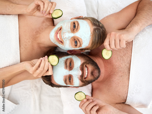 Couple, portrait and facial with cucumber in spa for face glow, skincare and self care together. Above man, happy woman and beauty mask with fruit for dermatology, wellness and peace in luxury salon