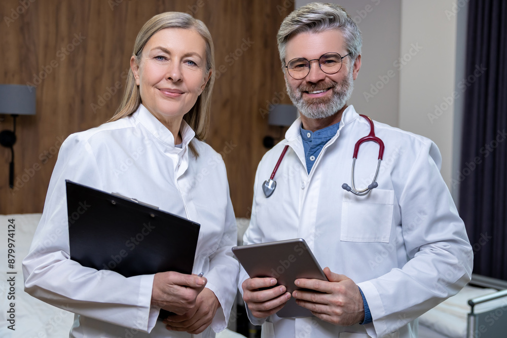 Doctors in lab coats standing close and looking confident Doctors in lab coats standing close and looking confident