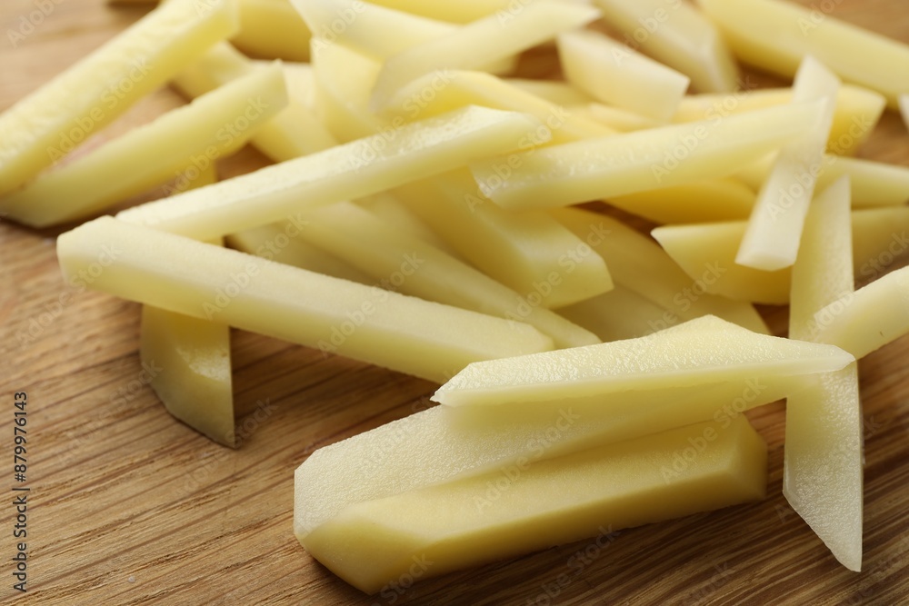 Cut fresh raw potatoes on wooden table, closeup Cut fresh raw potatoes on wooden table, closeup