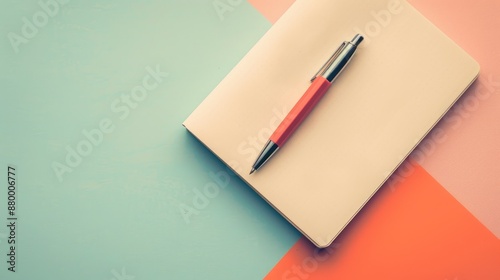 Pen and notebook on pastel background viewed from above