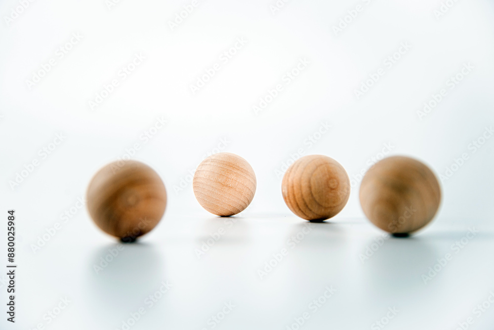Round wooden balls, spaced apart, app stack on white background, Copy Space Round wooden balls, spaced apart, app stack on white background, Copy Space