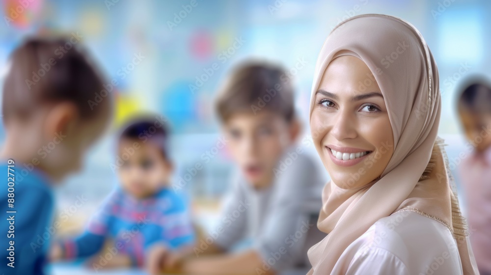 A woman wearing a head scarf smiles at the camera A woman wearing a head scarf smiles at the camera