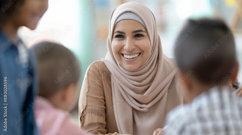 A woman wearing a hijab is smiling at a group of children A woman wearing a hijab is smiling at a group of children