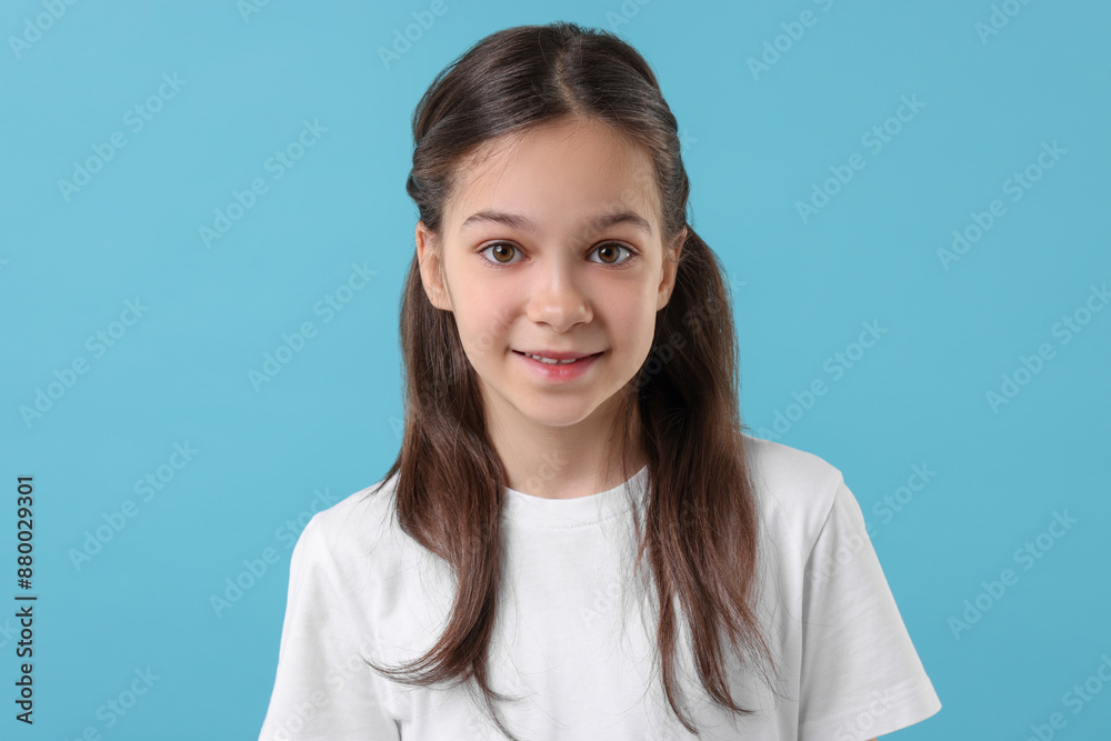 Portrait of beautiful girl on light blue background Portrait of beautiful girl on light blue background