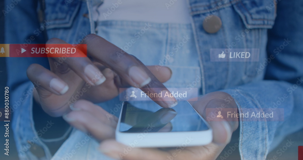 Fototapeta premium Image of social media icons floating against mid section of woman using smartphone